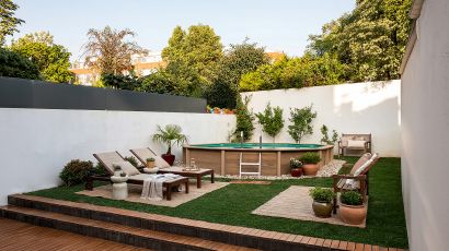 Naturalis concrete swimming pool with a wood-effect finish, set within a garden